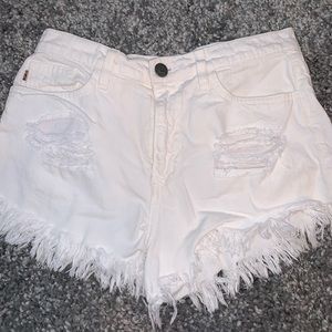 Distressed white jean shorts